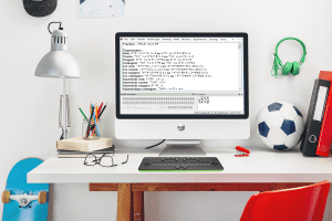 b.note Braille Display on a white desk in front of a monitor